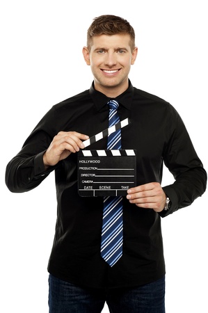 Young guy holding clapboard. Its showtimeの写真素材