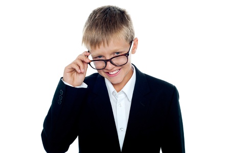 Young business boy looking through his glasses. Taking a closer lookの写真素材