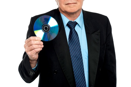 Cropped image of a male showing compact disk to the camera. Blank DVDの写真素材