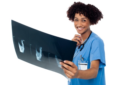 Young smiling female surgeon holding x-ray sheet and looking at camera.