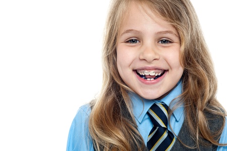 Pretty elementary school girl posing cheerfully. Closeup shot.
