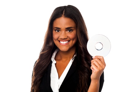 Young smiling businesswoman showing CD to the cameraの写真素材
