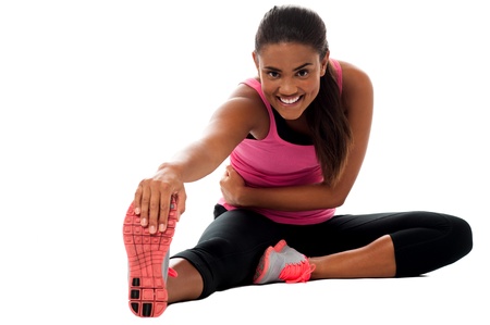 Beautiful young girl doing stretching exercise isolated on white