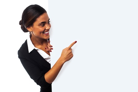 Place your business ad here. Woman pointing at blank whiteboardの写真素材