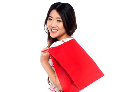 Young charming girl carrying shopping bagの写真素材
