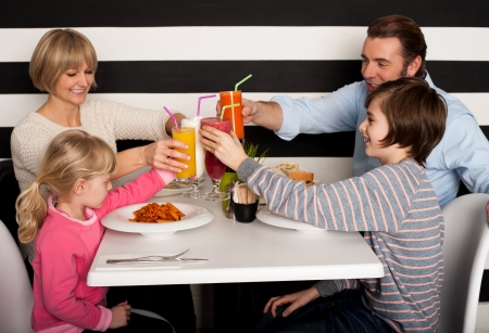 It's celebration time. Family toasting smoothies. It's celebration time. Family toasting smoothies.