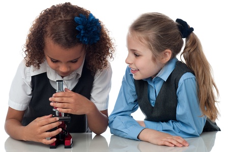 School girls using a microscope in labの写真素材