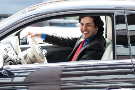 Young professional driving his new luxury carの写真素材