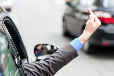 Man showing middle finger from car window  Evil gesture の写真素材
