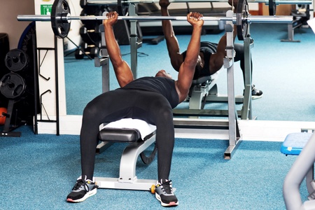 Young bodybuilder training in fitness center 