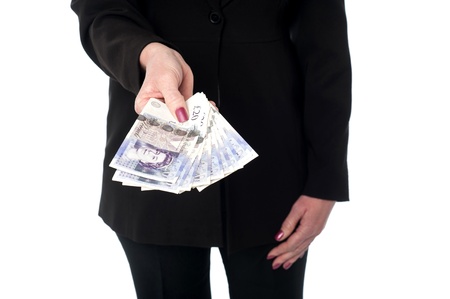 Cropped image of a woman showing pounds currency notesの写真素材