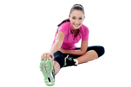 Beautiful young fit woman doing stretching exercise