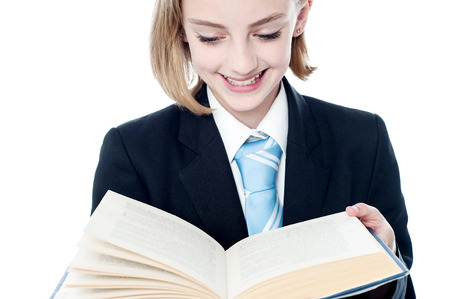 Young girl in business suit reading a bookの写真素材