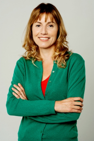 Middle aged casual lady posing with arms foldedの写真素材