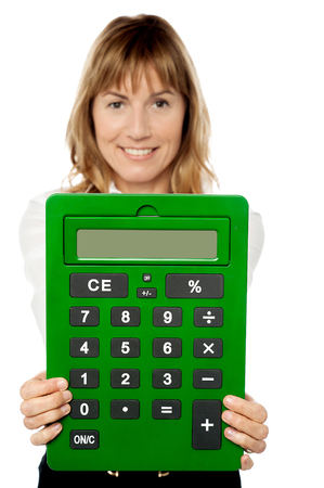 Smiling woman showing big green calculatorの写真素材