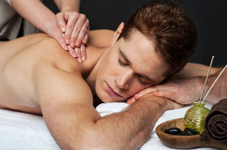 A good looking man getting a back massageの写真素材