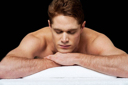 Man relaxing on a massage bed at spaの写真素材