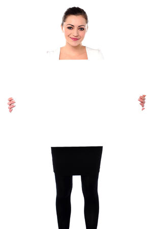 Pretty young woman holding blank ad boardの写真素材