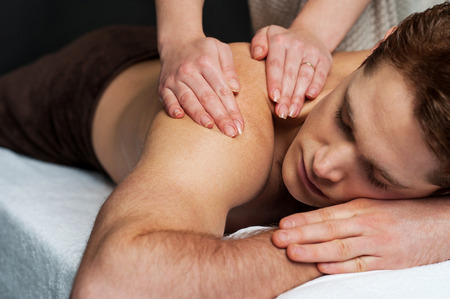 Young man getting massage in the beauty salonの写真素材