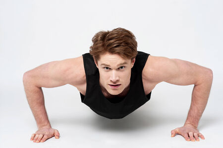 Handsome man working out pushing up on floor