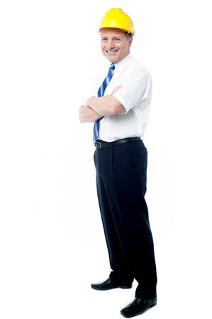 Smiling senior architect posing with ams crossedの写真素材