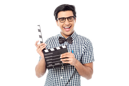 Young man holding movie clapboard isolated on white の写真素材