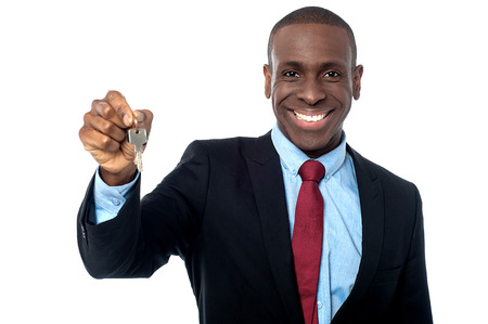 Real estate agent offering keys to the new homeの写真素材