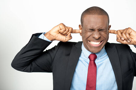 African businessman closing ear by his handsの写真素材
