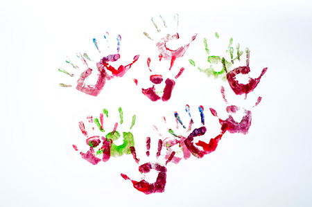 Colorful hand prints of kids over white の写真素材