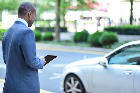 Rear view of businessman holding digital tablet