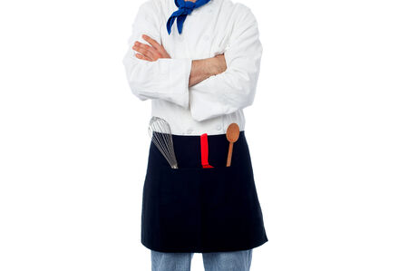 Chef with his arms folded and utensilsの写真素材