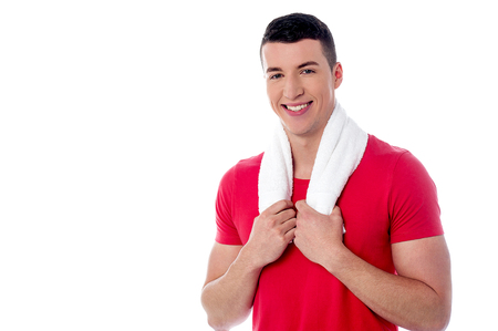 Smiling male fitness trainer, towel around his neckの写真素材