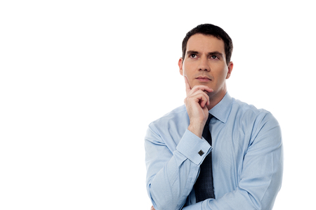 Handsome male executive thinking about somethingの写真素材