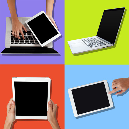 Human hand using laptop and holding tabletの写真素材