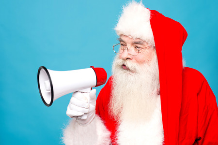 Santa claus making announcement in megaphoneの写真素材