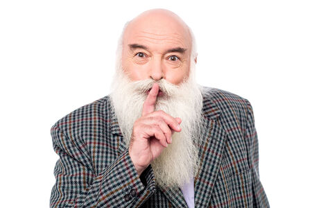Senior man asking to keep quiet, silent gesture.