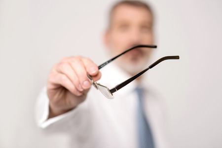Businessman taking his eyeglasses to wearの写真素材
