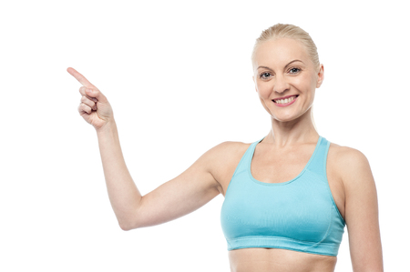 Fitness woman pointing to copy spaceの写真素材