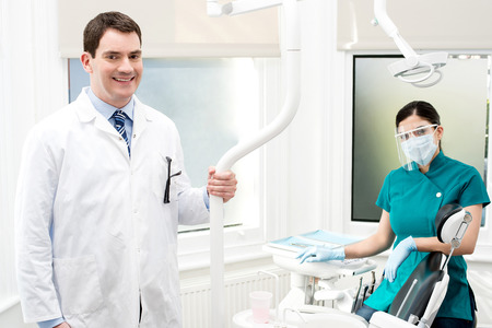 Male dentist and his female assistant posingの写真素材
