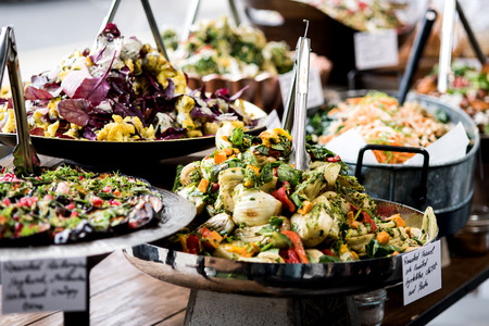 Salads displayed on buffet in individual containersの写真素材