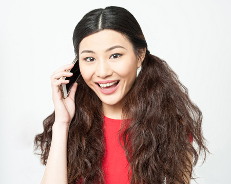 Cheerful woman speaking on her cellphoneの写真素材