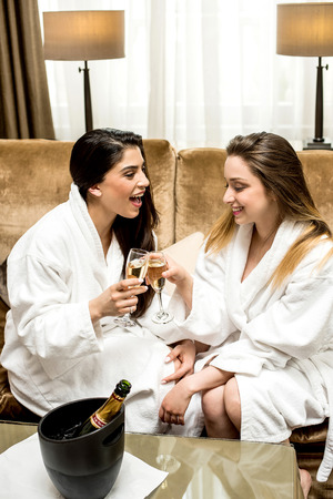 Relaxed young women enjoying wineの写真素材