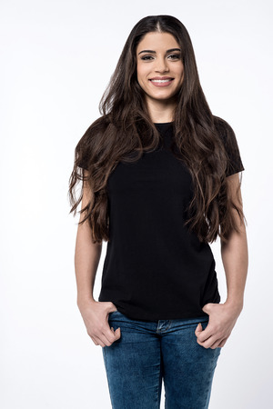 Trendy woman standing with hands in pocketsの写真素材