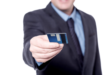 Cropped image of a businessman giving credit cardの写真素材