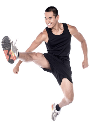 Young man doing stretching exercises over whiteの写真素材