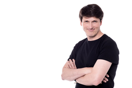 Middle aged man posing to camera with crossed arms.の写真素材