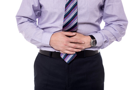Close-up mid section of a businessman with stomach pain.の写真素材