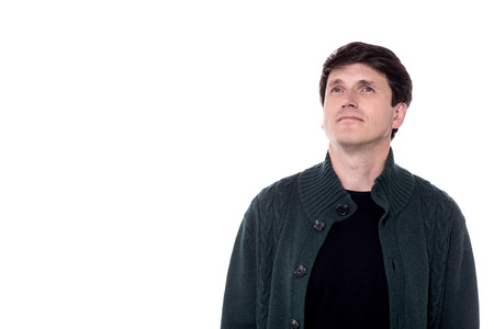 Casual man in knitted wear looking away.の写真素材