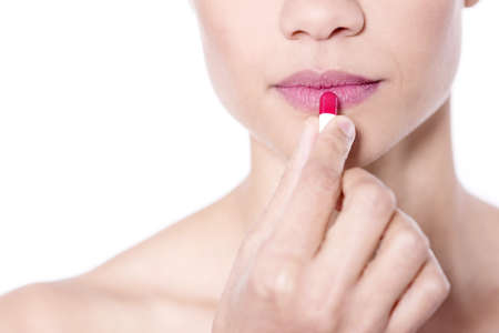 Close up portrait of attractive girl rouging her lipsの写真素材