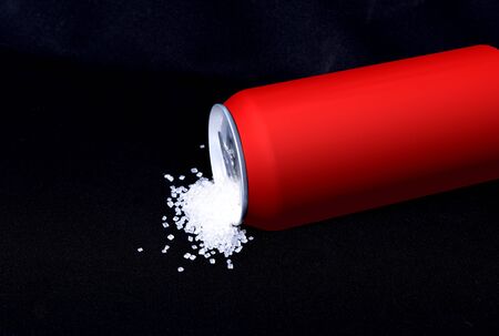 Soda can pouring a high amount of sugar  Refresh drink isolated on black background, diet and sweet...